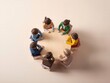 © Mdsiyam - Miniature people in a circle, discussing together, teamwork, collaboration, beige background, soft lighting