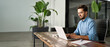 © insta_photos - Busy professional business man executive, young male corporate worker, latin businessman wearing glasses typing on computer technology using laptop searching on web working at office workplace desk.
