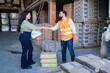 © AntonioDiaz - Handshake between business professionals in a construction supply warehouse, completing a b2b deal for building materials