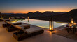 © AamirSohail - Luxurious desert resort infinity pool glows invitingly under twilight mountain silhouettes with lanterns