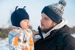 © phpetrunina14 - Father and Baby in Winter Landscape Copy Space