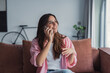 © Daniel - A happy woman relaxes on the couch while talking on her smartphone, smiling as she shares news with family and enjoys a pleasant personal conversation using modern mobile communication at home