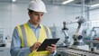© lian - Factory worker with tablet and robotic arm