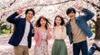 © WOWSTYLE - 満開の桜と笑顔の若者たち