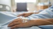 © Diah - Patient receiving intravenous infusion in hospital bed, close-up on IV drip in arm