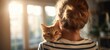 © Elena  - The Cat Resting on a Woman's Shoulder in Warm Sunlit Home Interior
