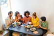 © Westend61 - Group of friends having lunch in a restaurant