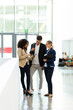 © Westend61 - Young business people using a tablet in a foyer