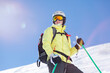 © Westend61 - Austria, Bludenz, woman with ski helmet and avalanche backpack in the mountains