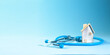© Artvibe - Miniature house and stethoscope on blue background with copy space