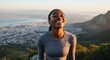 © TheseusStock - Sunlit Black woman closed eyes smiling freedom high mountain viewpoint city adventure travel lifestyle