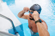 © Halfpoint - Male swimmer is preparing for swim in pool.