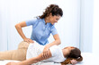 © Graphicroyalty - Professional female physiotherapist performing a spinal manual adjustment on a female patient in a clinic room. Effective chiropractic care for back pain relief, physical therapy, and wellness therapy