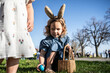 © ADDICTIVE STOCK - Easter egg hunt with family in springtime