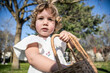 © ADDICTIVE STOCK - Girl enjoying Easter with basket in park