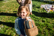 © ADDICTIVE STOCK - Girl with basket celebrating Easter outdoors