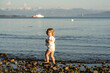 © ADDICTIVE STOCK - Young child exploring rocks by the sea