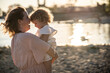 © ADDICTIVE STOCK - Loving mother and child at sunset on the beach