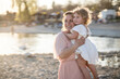 © ADDICTIVE STOCK - Mother and child enjoying a beach sunset