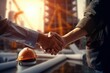 © nsit0108 - Two construction workers or business people shaking hands, symbolizing successful project agreement