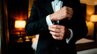 © Xenia - Groom adjusting cufflinks on tuxedo suit. Man dressing for formal event or wedding
