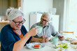 © Davor - Smiling senior couple having coffee in home kitchen
