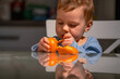 © zwiebackesser - Toddler enjoying mandarin while learning independence.