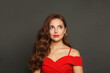 © artmim - Lovely brunette woman with trendy make-up and brown curly hair wavy hairstyle and red lips makeup on black background