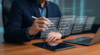 © Sidra Anwer - Businessman planning project milestones on digital tablet in modern office