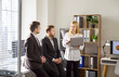 © Studio Romantic - Colleagues team discuss laptop finance strategy analysis. In a bright office, business meeting planning continues. They review reports and charts. Focused teamwork enables financial decisions.