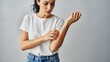 © Rakibul - Woman experiencing discomfort on her arm with a visible red mark.