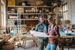 © Halfpoint - Two carpenters man and woman talking about design of products. Small business concept.
