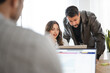 © Studio Marmellata - A man and a woman collaborate on a project, reviewing information on a tablet in an office setting.