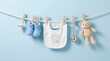 © All Animation - Newborn baby boy essentials hanging on clothesline including booties and teddy bear on blue background