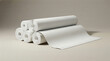 © Jon Stock - Stacked rolls of light beige textured wallpaper ready for home decoration projects on a clean studio background