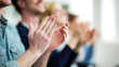 © Smejanka - Close up of an audience clapping hands at a seminar