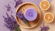 © Oleh - Lavender flowers, a lit purple candle on a wooden tray, and two orange slices create a top down view promoting a soothing atmosphere for spa, wellness, and self care