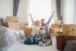 © Serhii - Happy family moving to new home celebrating relocation