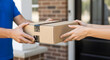 © A5 - Close-up of a delivery person handing a cardboard package to a recipient at their front door, emphasizing home delivery and e-commerce services.