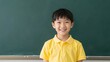 © Studicon - Smiling young student stands in front of the blackboard in the classroom