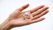 © unairakstudio - A stunning multi-stone diamond ring held on an open palm against a pure white background.