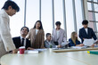 © eakgrungenerd - Diverse business team reviewing financial reports during office meeting. Professionals discussing charts and strategy. Corporate teamwork, collaboration, leadership, data analysis concept.