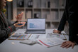 © Apichat - Business colleagues discussing data and financial report