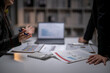 © Apichat - Business people discussing financial data during meeting
