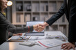 © Apichat - Business people shaking hands celebrating partnership deal