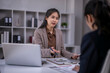 © Apichat - Asian businesswoman consulting client in office meeting
