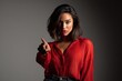 © Vlad - Elegant Latin woman pose with left-hand pointing under warm studio lighting