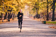 © Westend61 - Young woman jogging in autumn forest