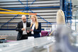 © Westend61 - Businessman and businesswoman with tablet discussing in factory