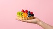 © wrisand - hand holding a fruit tart